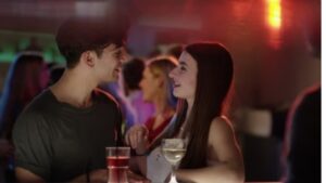 A man with an attractive woman in a bar
