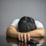 A man frustrated because a woman she likes is texting back